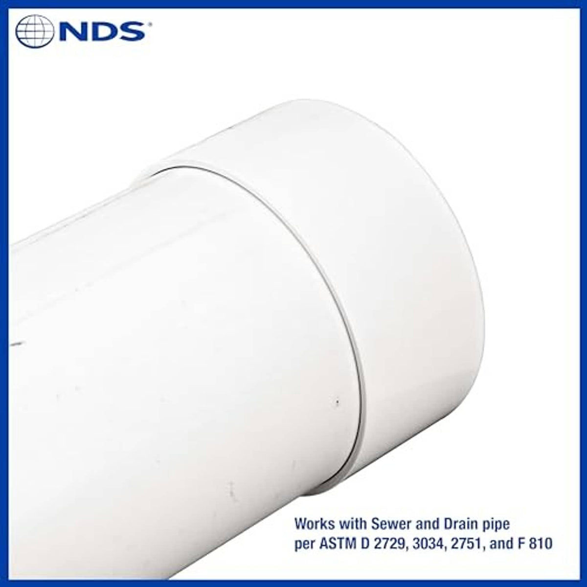 White 6-inch PVC S&D end cap fitted on pipe stub, close-up angle