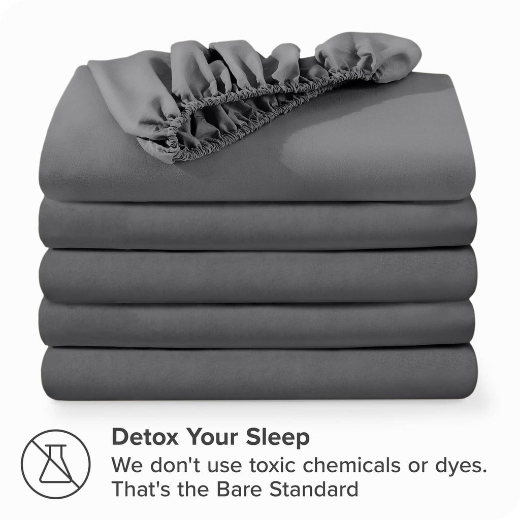 Grey fitted sheet set, neatly stacked microfiber sheets with elastic trim