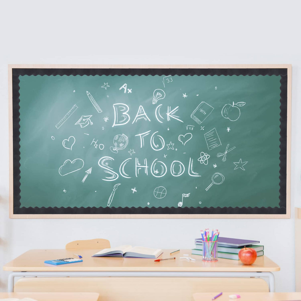 Chalkboard with “Back to School” writing and school-themed doodles