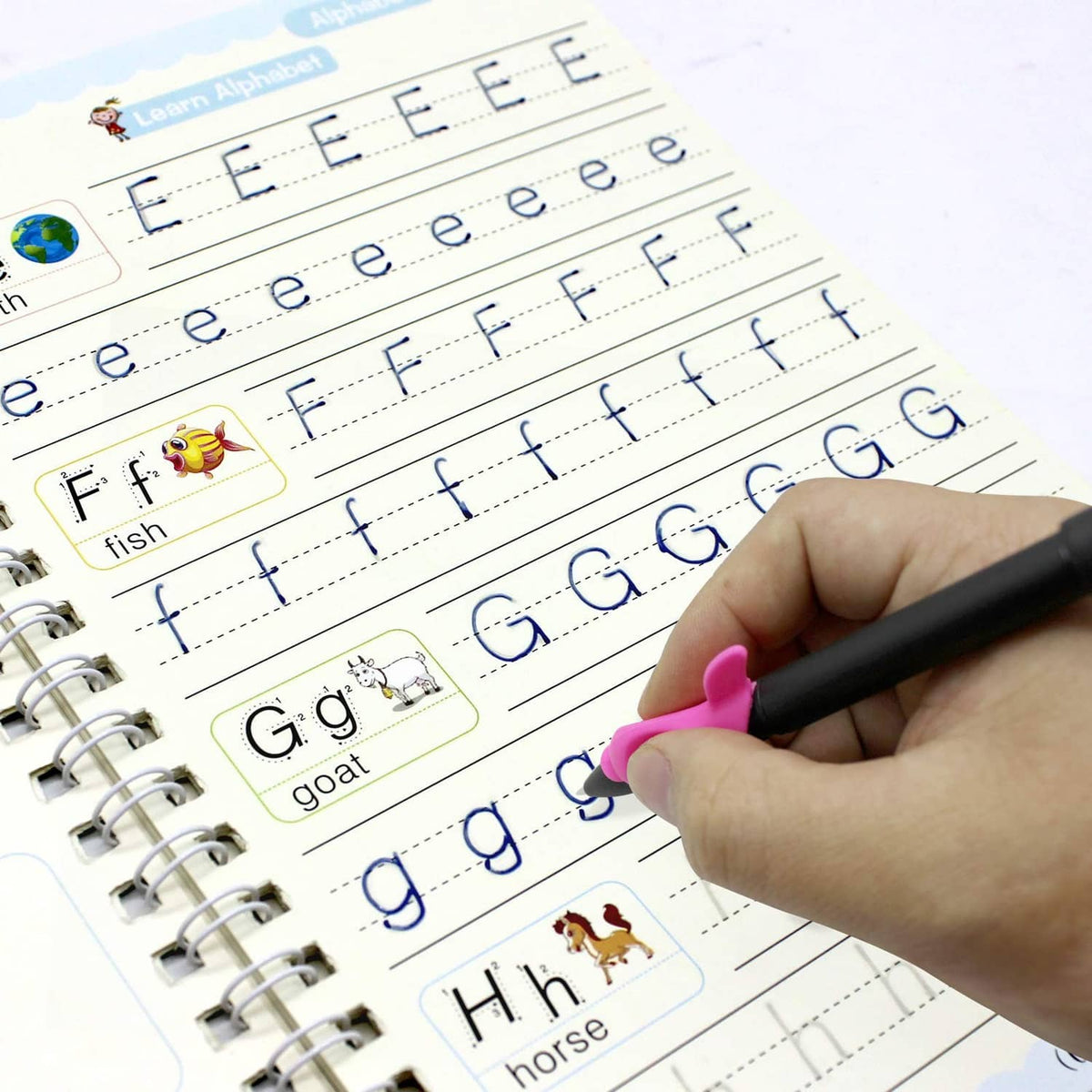 Handwriting practice copybook with alphabet tracing and a child writing with a pen