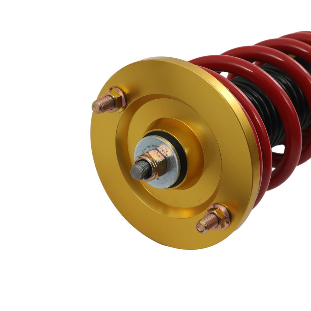 Gold top mount with bolts on coilover shock and red coil spring