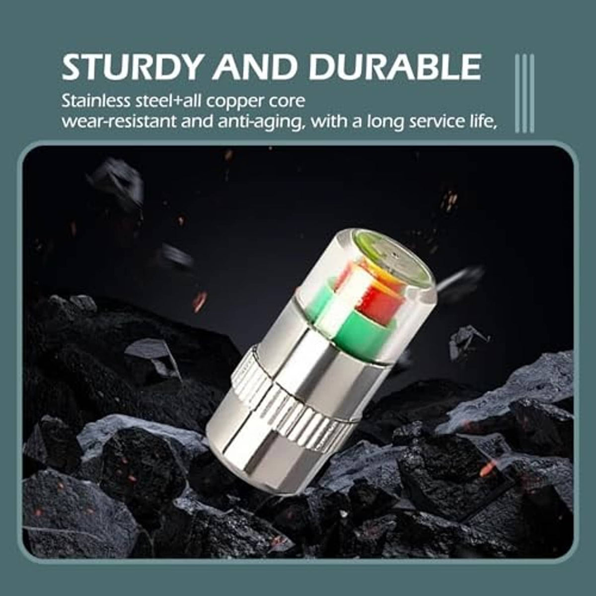 Chrome tire valve cap with green and red ring insert resting on rocks