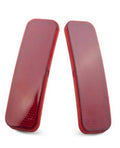 Pair of red rear bumper reflector tail lights with curved rectangular dotted lenses