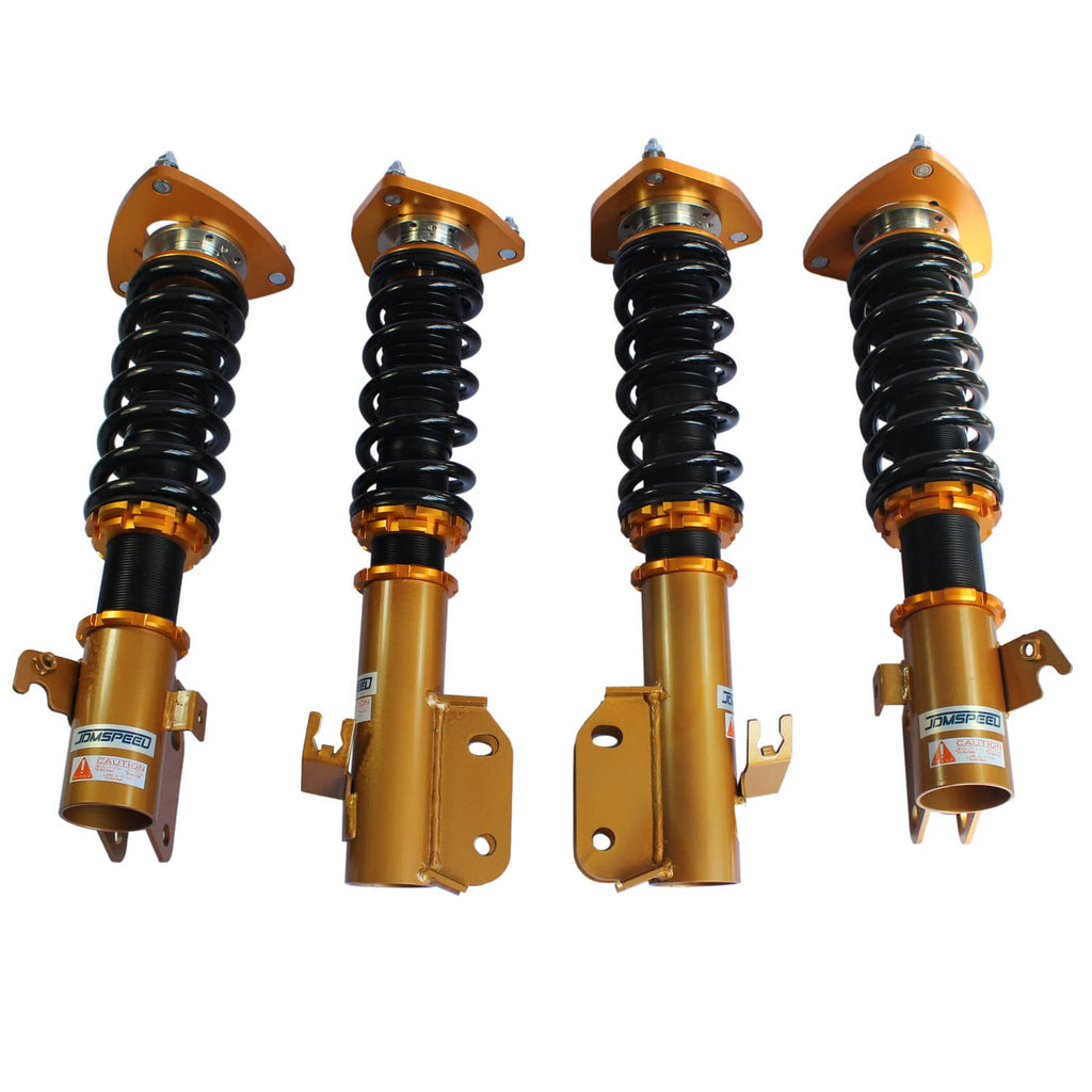 Set of four gold coilover struts with black coil springs, top hats, and brackets