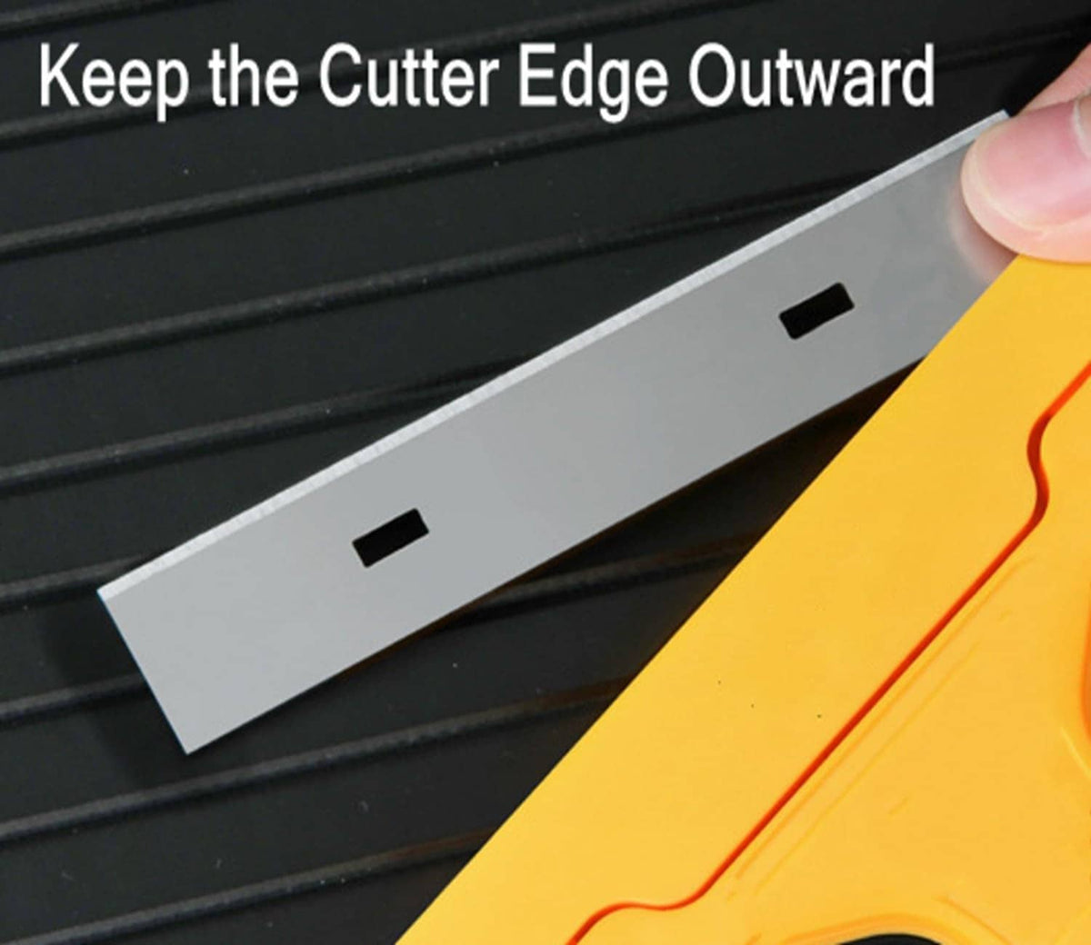 Yellow razor blade scraper showing cutter edge and blade guide in close-up