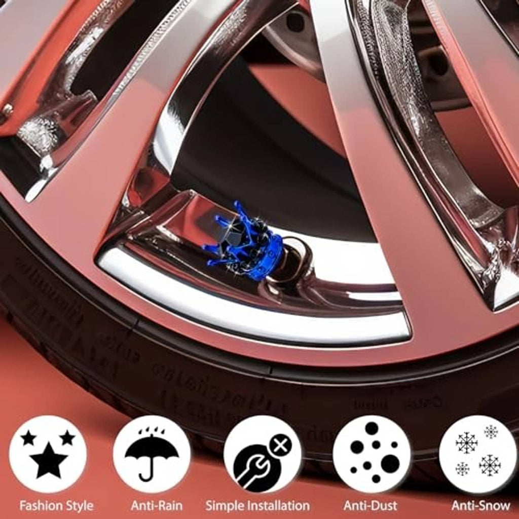 Blue crown tire valve stem cap with black faceted crystals, shown on car wheel