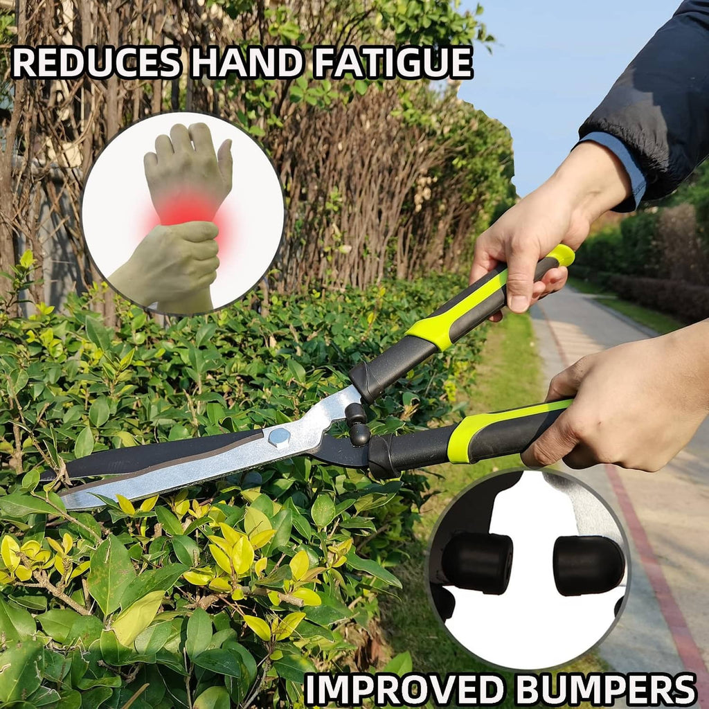 Manual hedge trimmer with green-and-yellow handles, silver blades, used with gloves