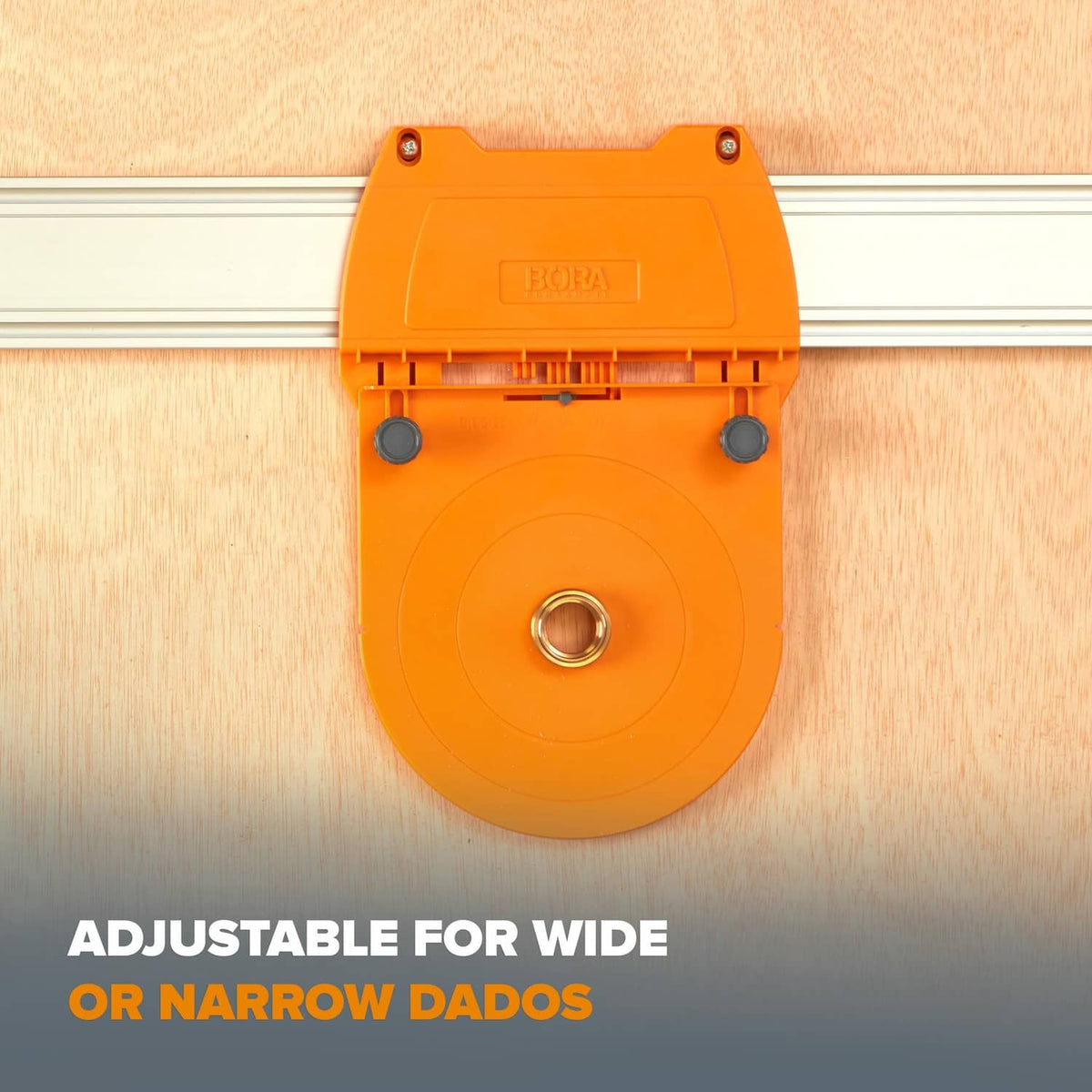 Orange Bora router dado jig mounted on wood with brass center bushing
