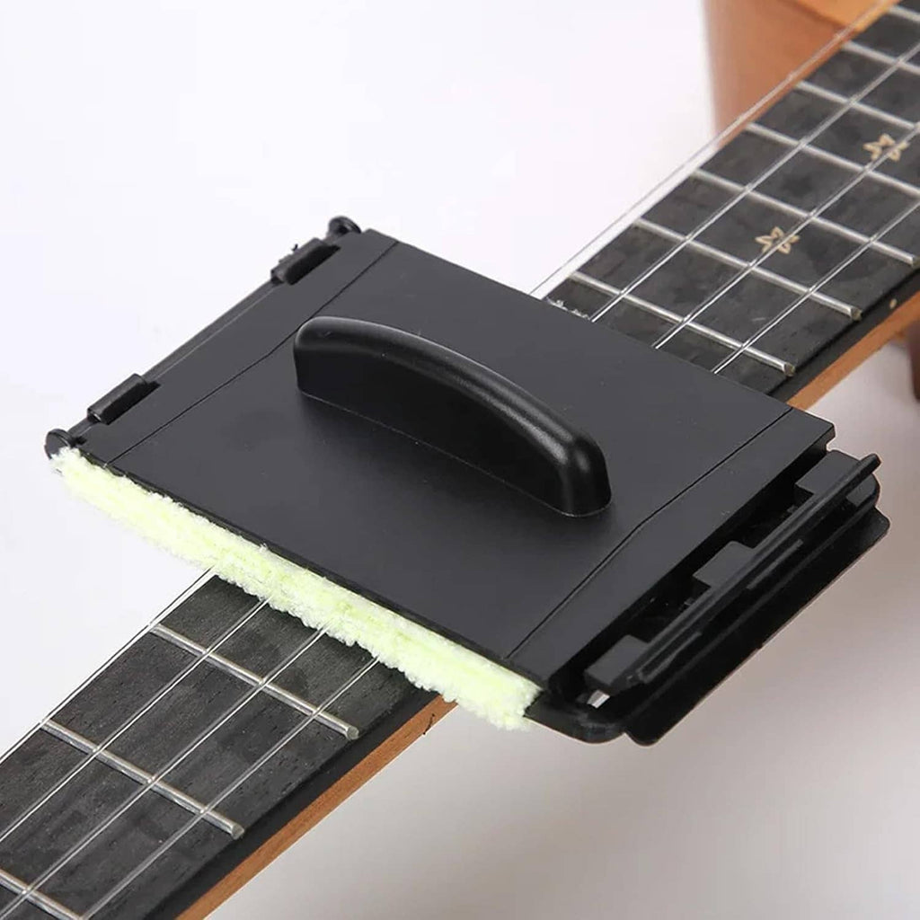 Guitar fretboard cleaning tool with black handle and pale yellow cloth