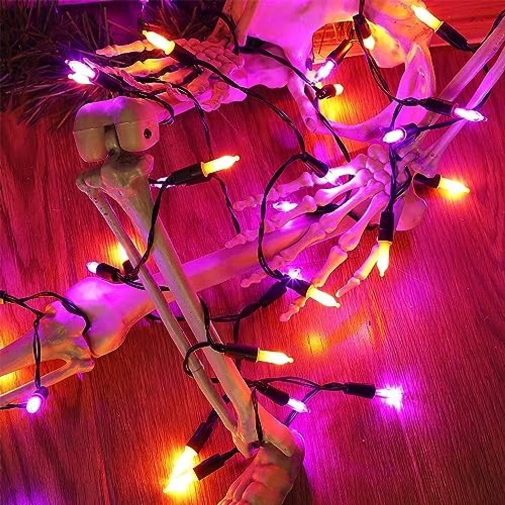 Glowing orange and purple mini LED string lights wrapped on black wire strands