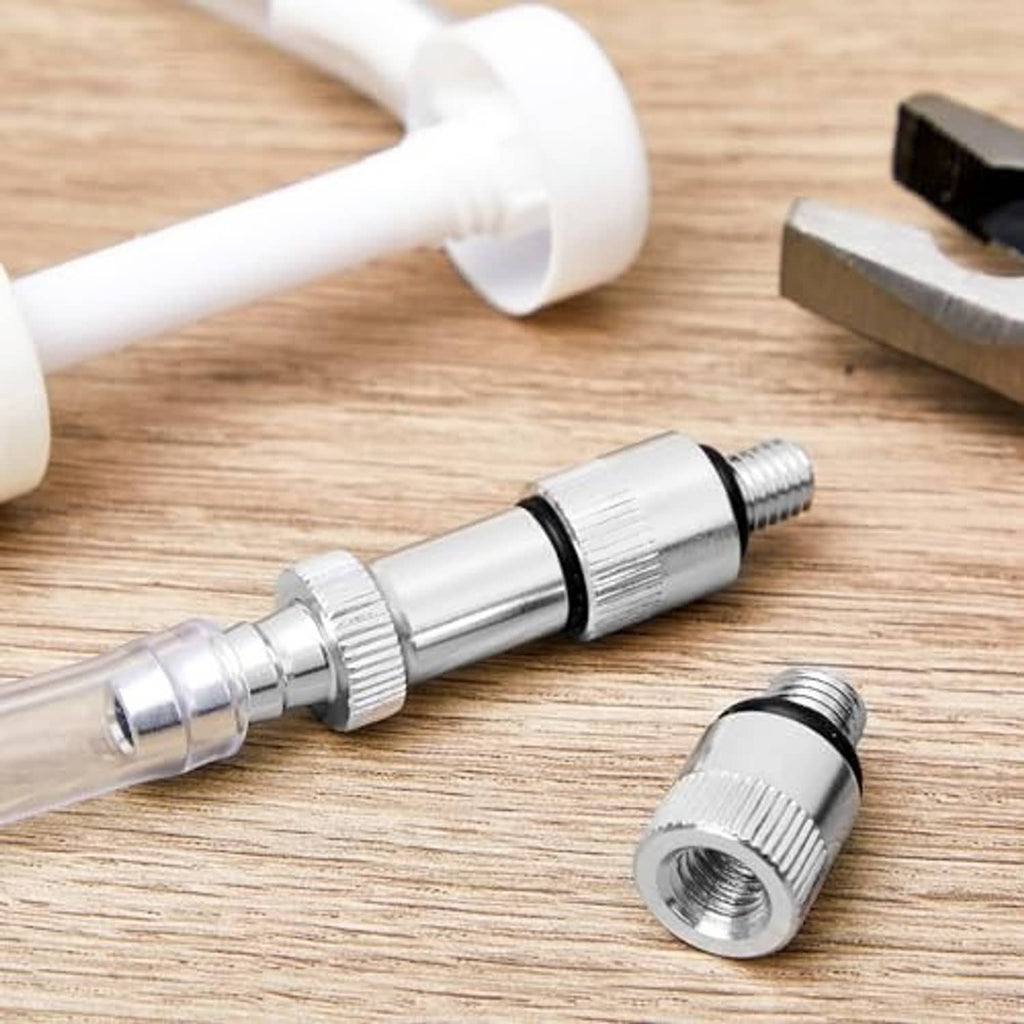 Stainless steel adapter fitting with ridged grip sleeve and threaded port, black sealing ring