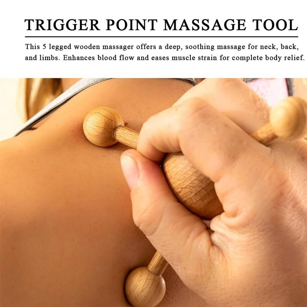 Wooden 5-legged trigger point massager pressing on upper back during use by hand.
