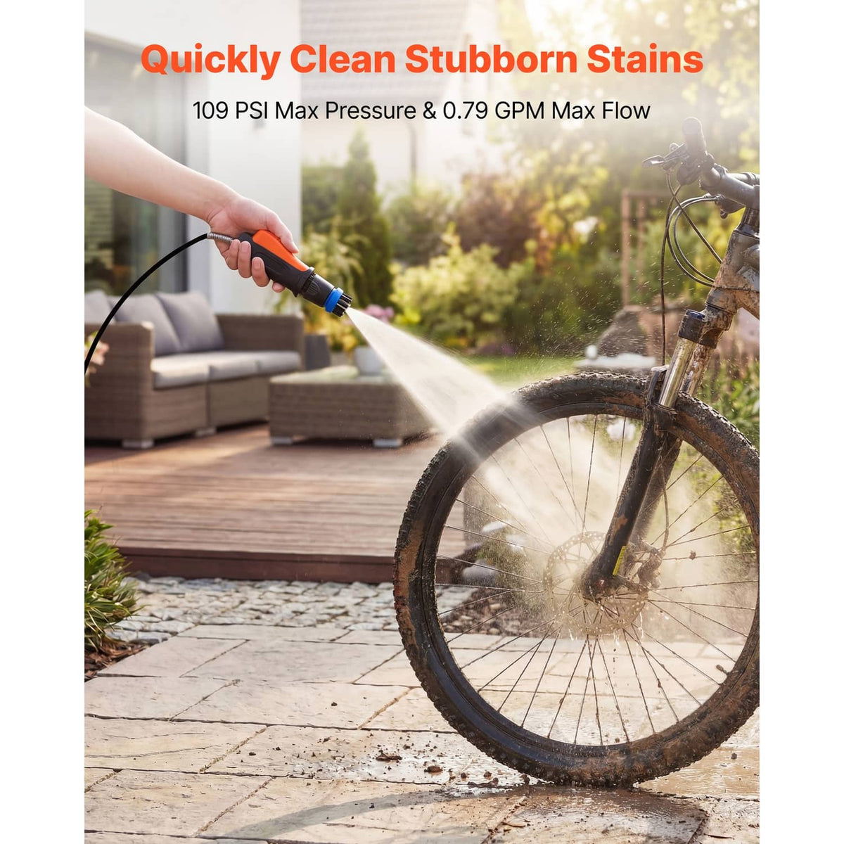 Portable cordless pressure washer producing a spray stream from an orange/gray unit