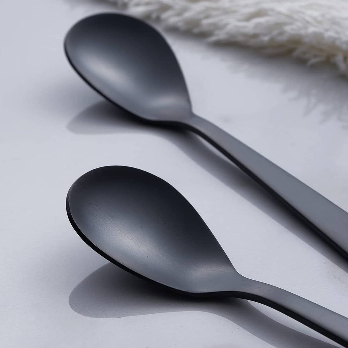 Matte black demitasse espresso spoon with smooth rounded bowl and slender handle