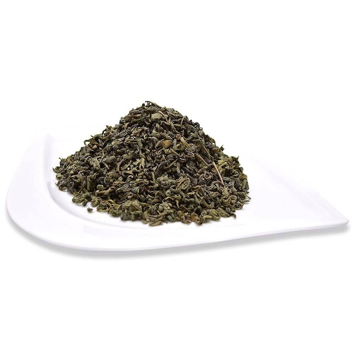 Organic pinhead gunpowder green tea leaves on white plate, dark green pellets