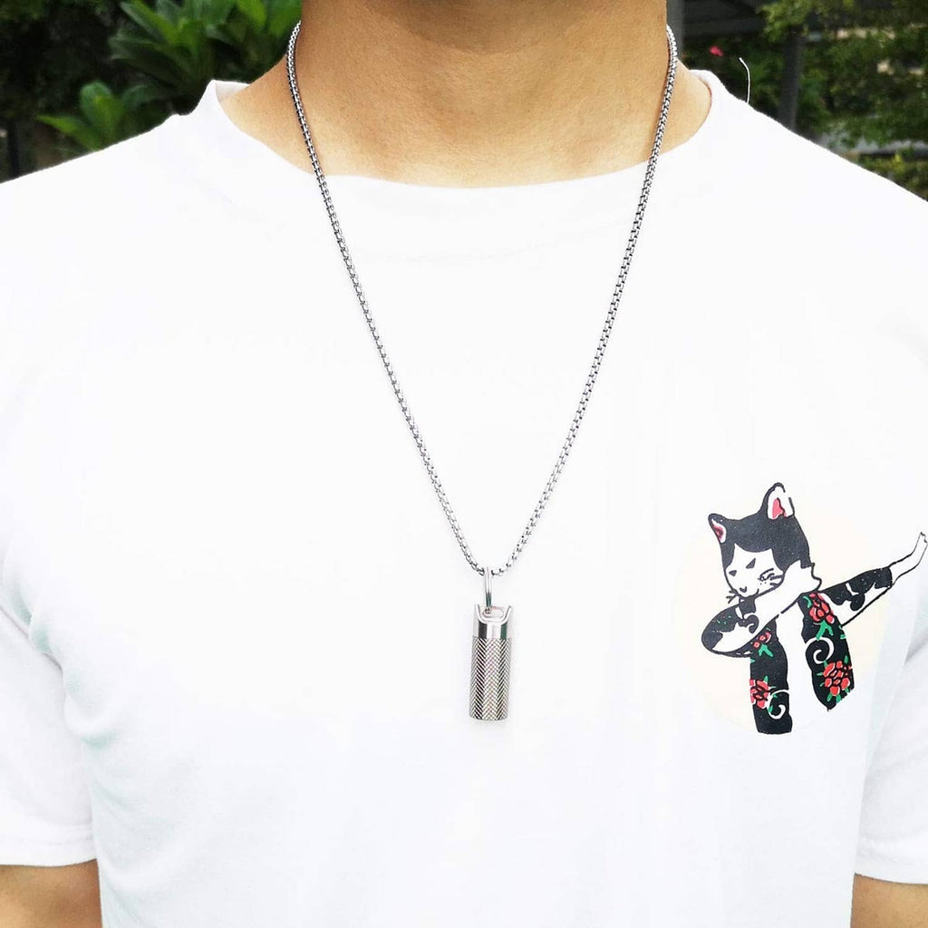 Titanium pill fob necklace with textured cylinder pendant hanging at the center of the chest