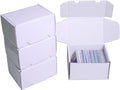 White cardboard card storage boxes, stacked and open with trading cards inside