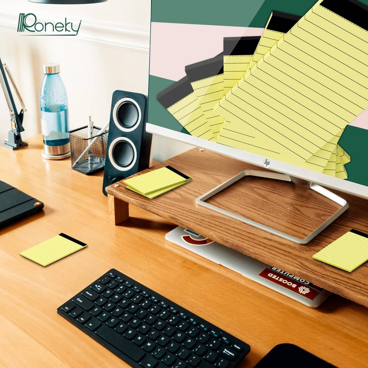 Yellow ruled notepad stack on desk, compact paper pages