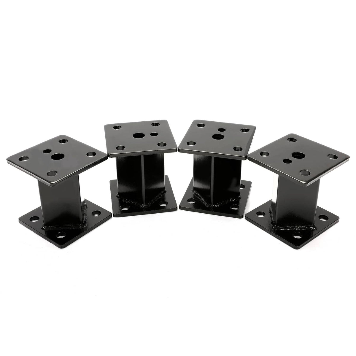 4 in block lift kit parts arranged: multiple black lift blocks with mounting plates