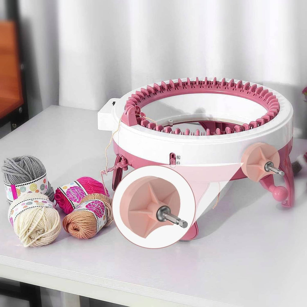 Knitting machine adapter on a pink-and-white knitting machine with yarn balls nearby
