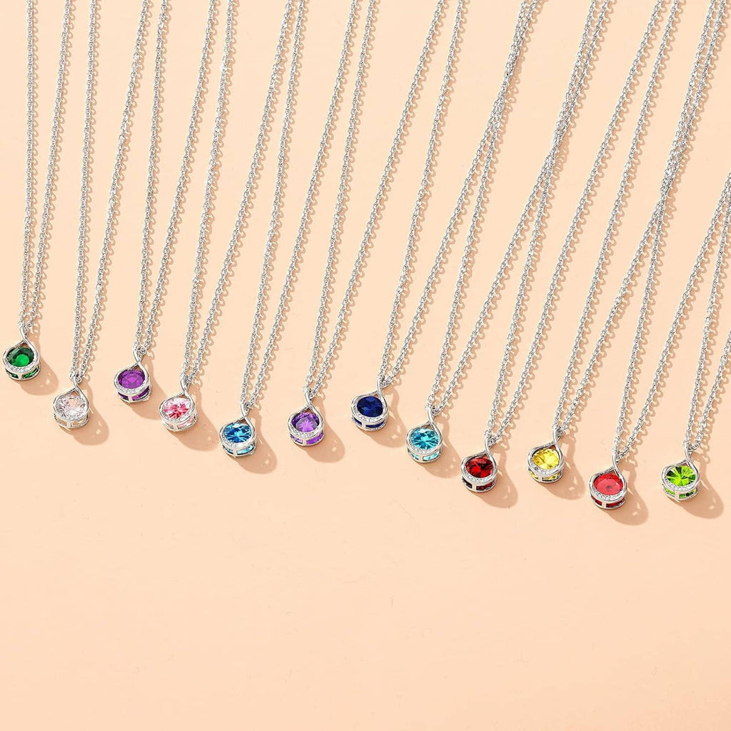 Row of silver birthstone-style charm necklaces with colorful teardrop pendants