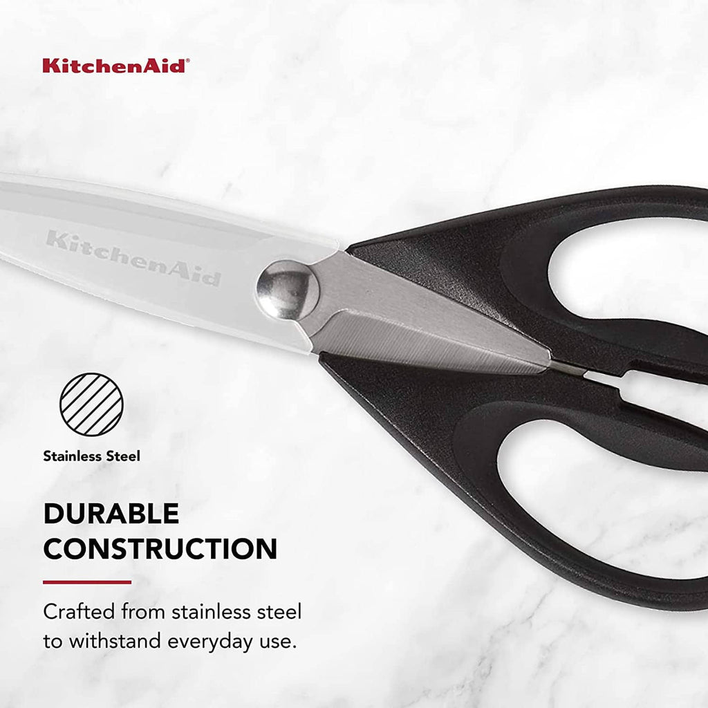 Close-up of stainless steel kitchen shears with black handles and protective guard