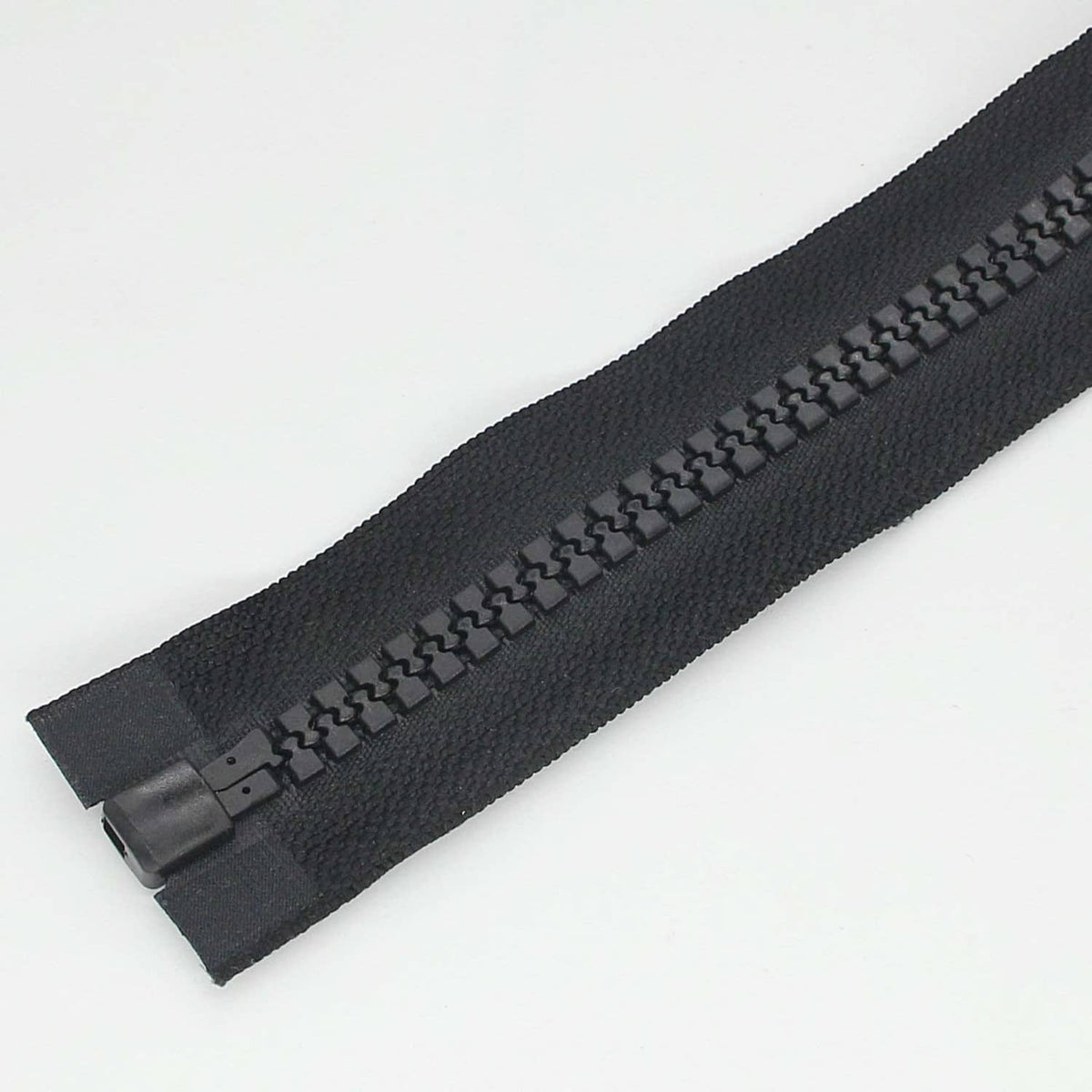 Black separating zipper tape with interlocking plastic teeth and bottom locking piece
