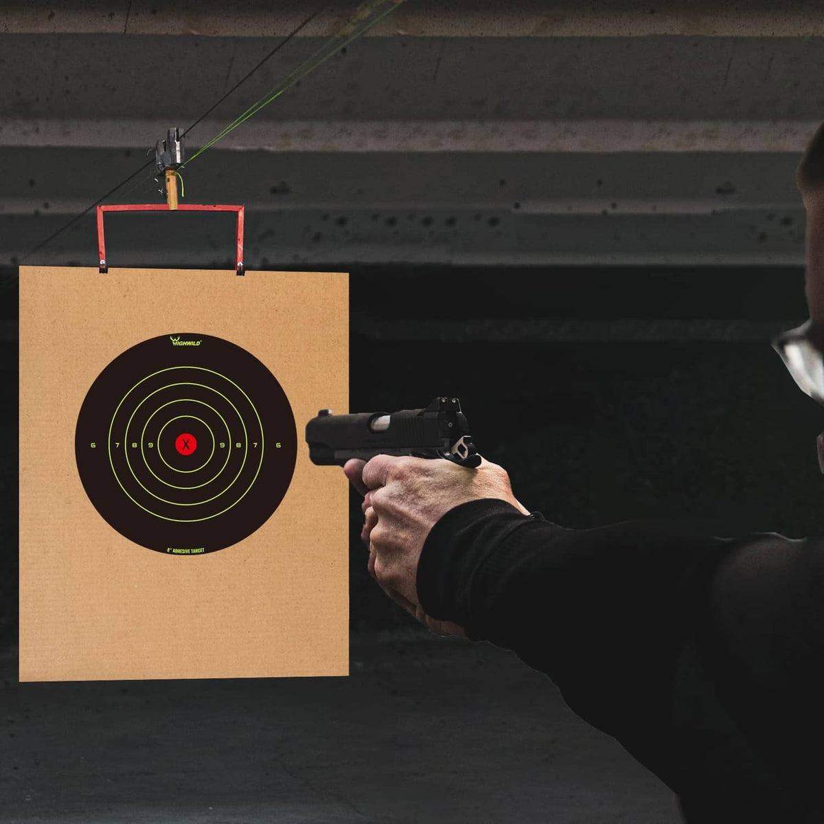 Adhesive bullseye target on cardboard with neon ring lines and red X center for shooting
