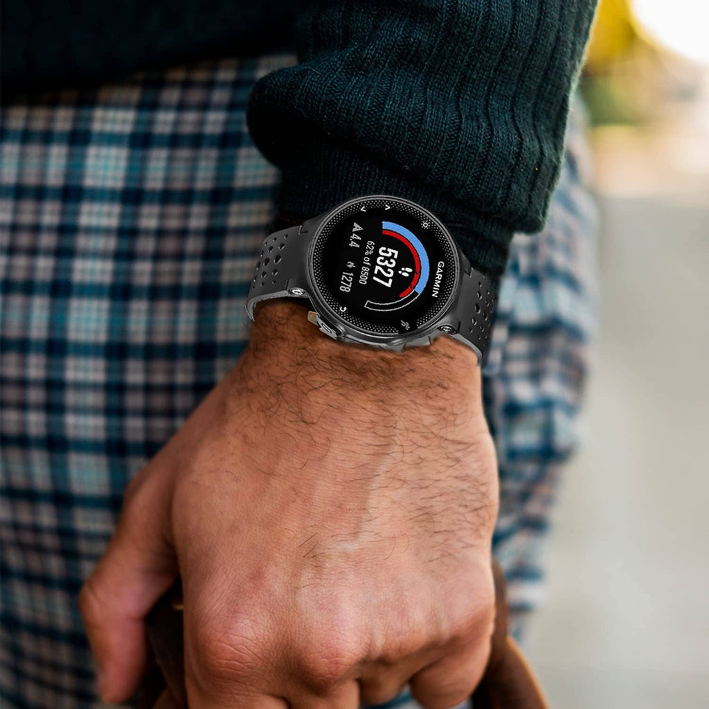 Black perforated smartwatch band on man's wrist with knit sweater