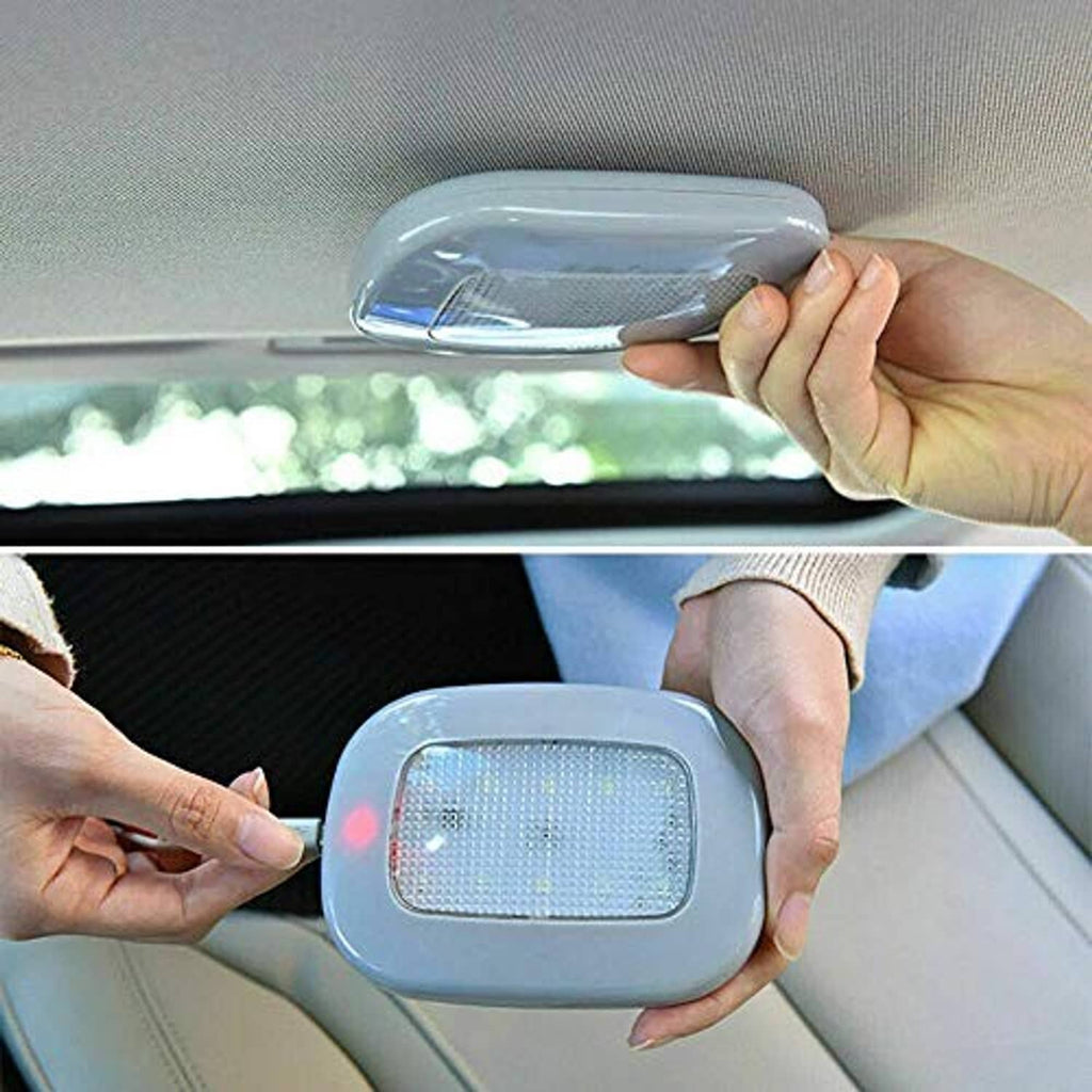 Hands installing rectangular LED dome light on car ceiling liner