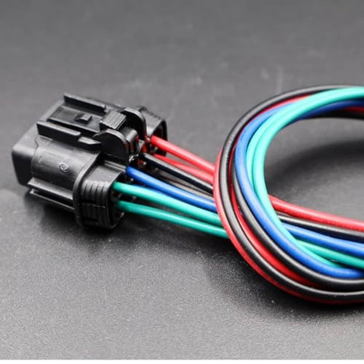 Headlamp connector plug with bundled red, green, blue, and black wires
