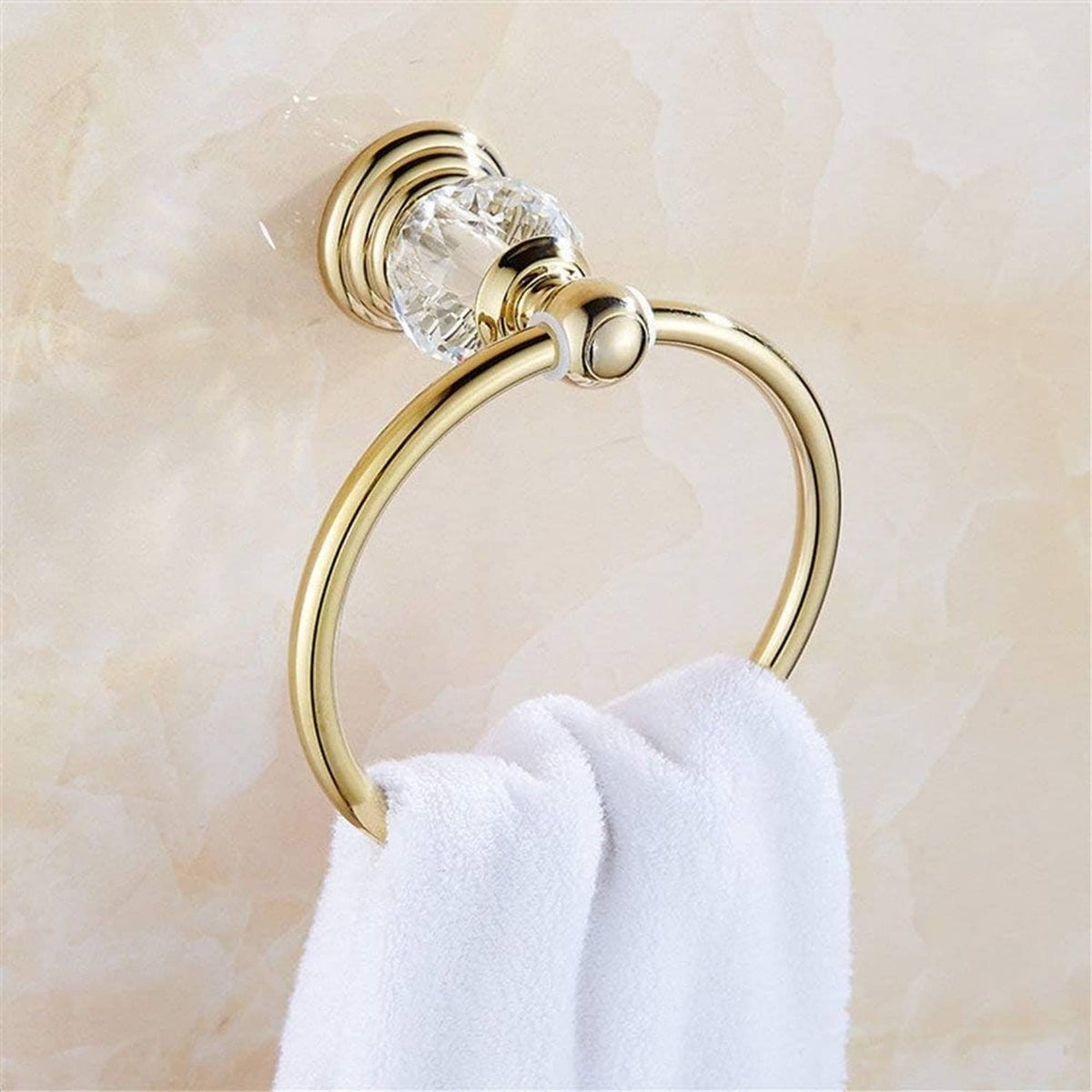 Gold towel ring with faceted crystal mount holding folded white towel