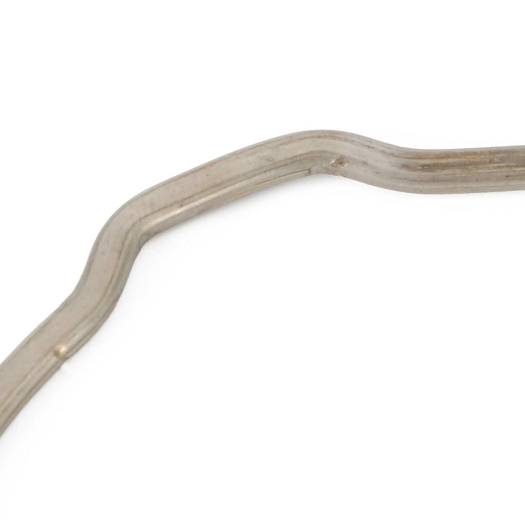 Close-up of silver curved gasket/retainer with beige sealant