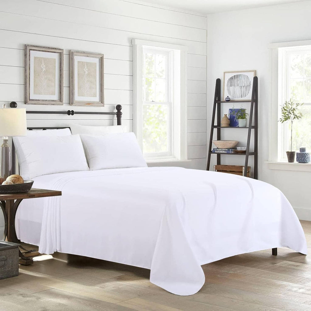 White king flat sheet and pillows on a bed with long fabric overhang