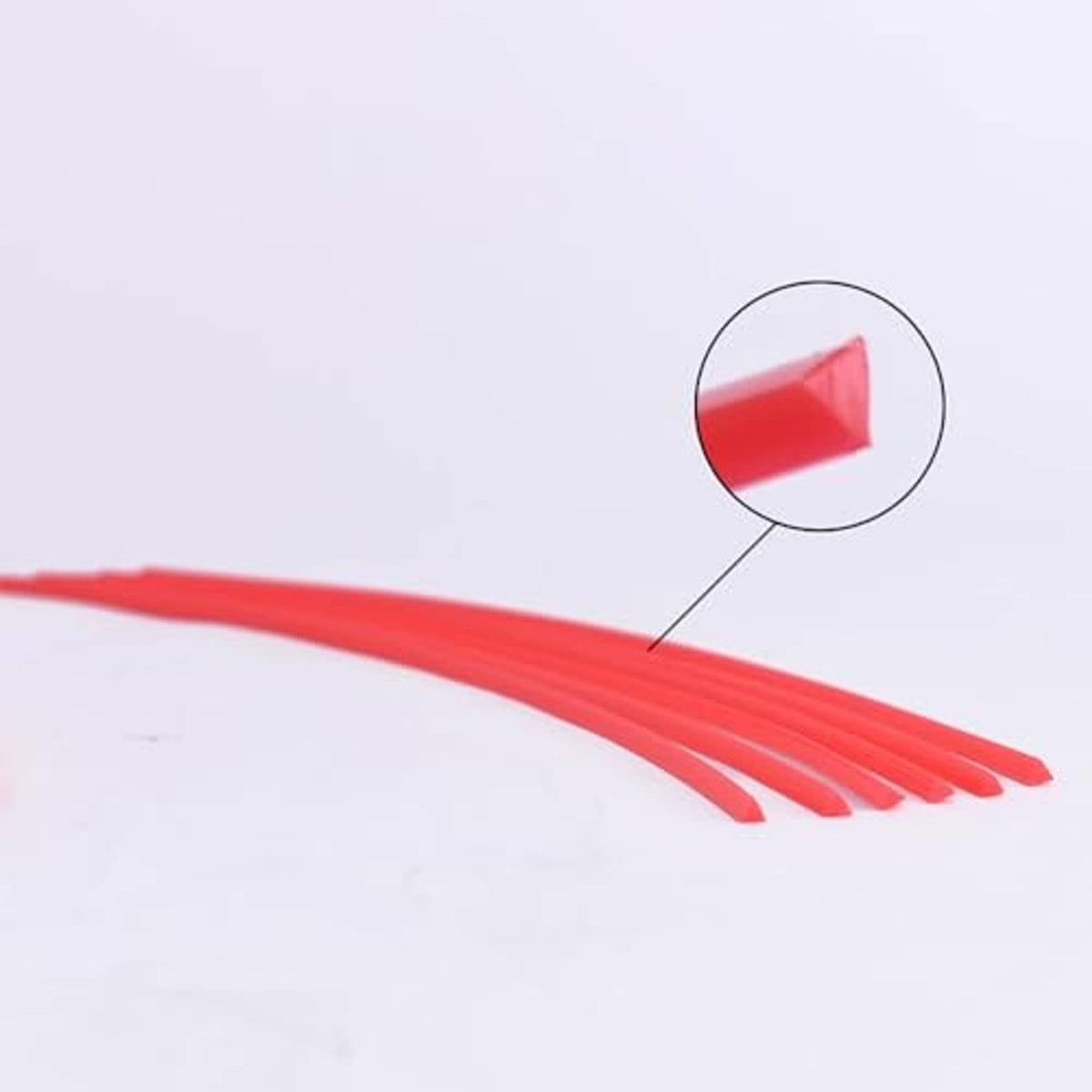 Close-up of red triangle string trimmer line strand ends