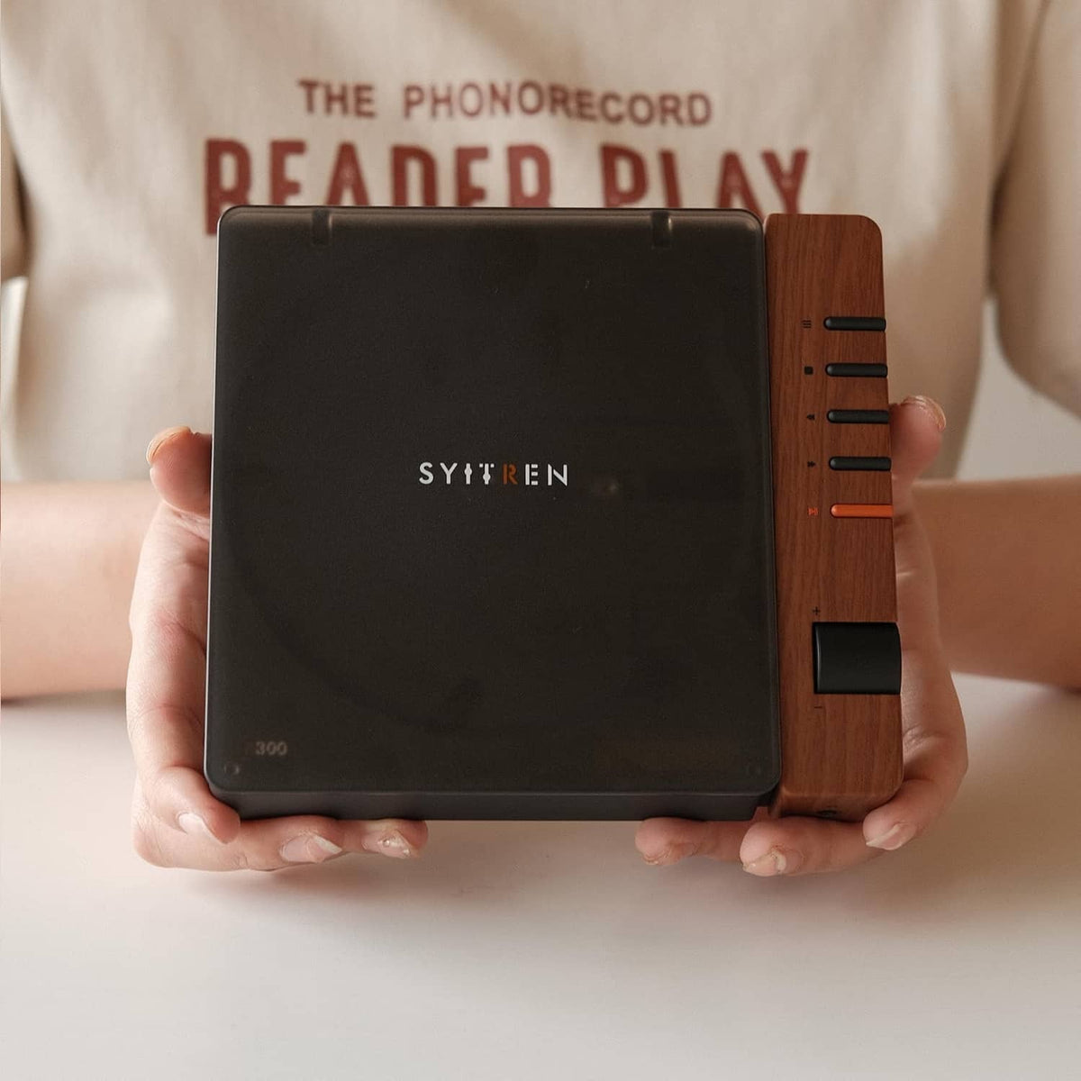 Portable CD player with wood side controls and front black face