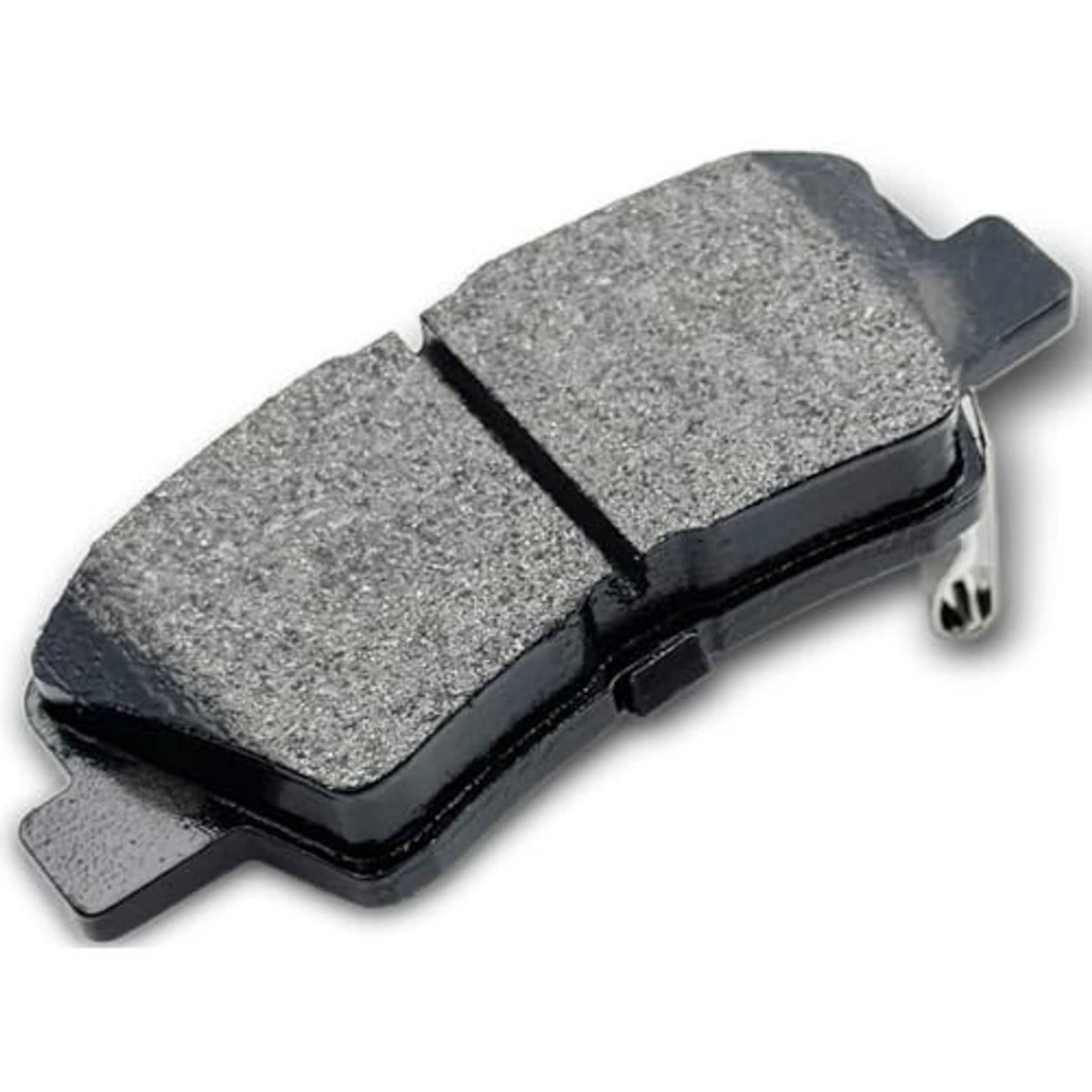 Gray ceramic brake pad with black backing and side latch tab, angled view