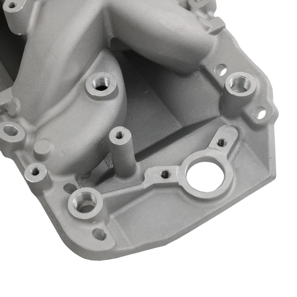 Dual-plane intake manifold underside with threaded ports and open channel cavities.