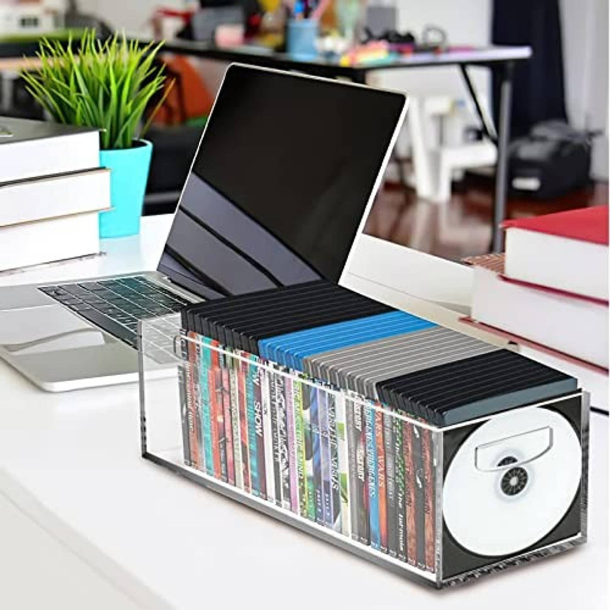 Clear acrylic DVD/CD storage box filled with CDs, with front handle