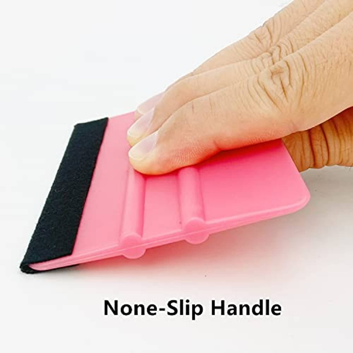 Hand holding pink vinyl squeegee tool with black felt edge and non-slip handle