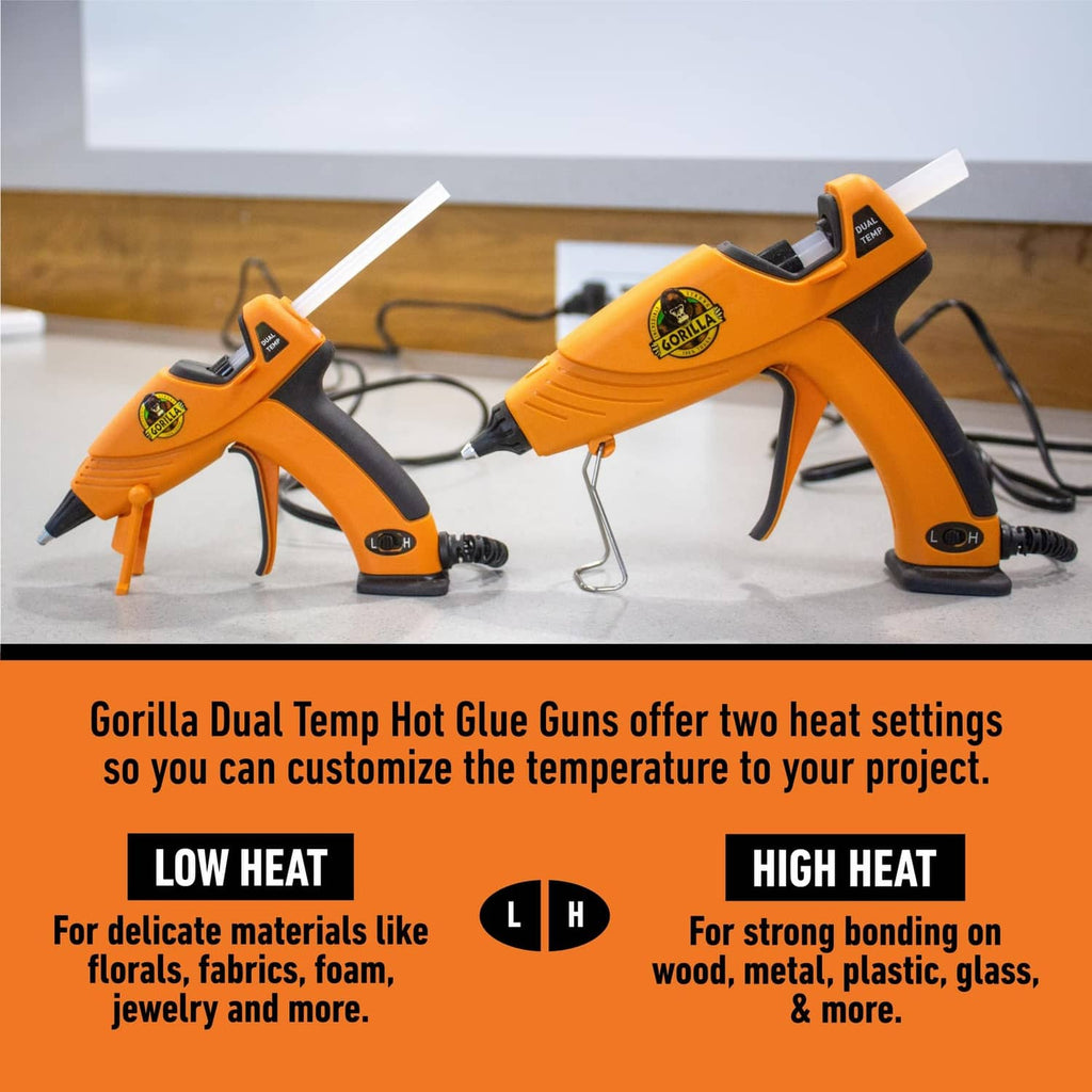 Pair of orange mini hot glue guns with cords and sticks, dual heat settings