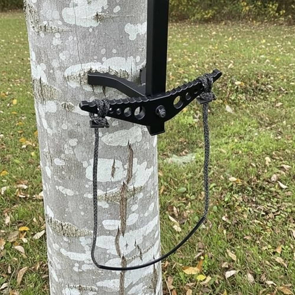 Rope step looped aider secured to a tree-mounted climbing bracket outdoors