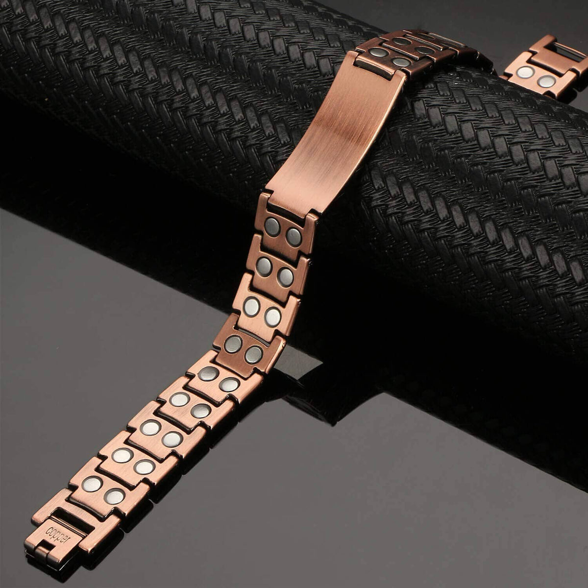 Copper magnetic bracelet close-up with studded links and rectangular clasp end