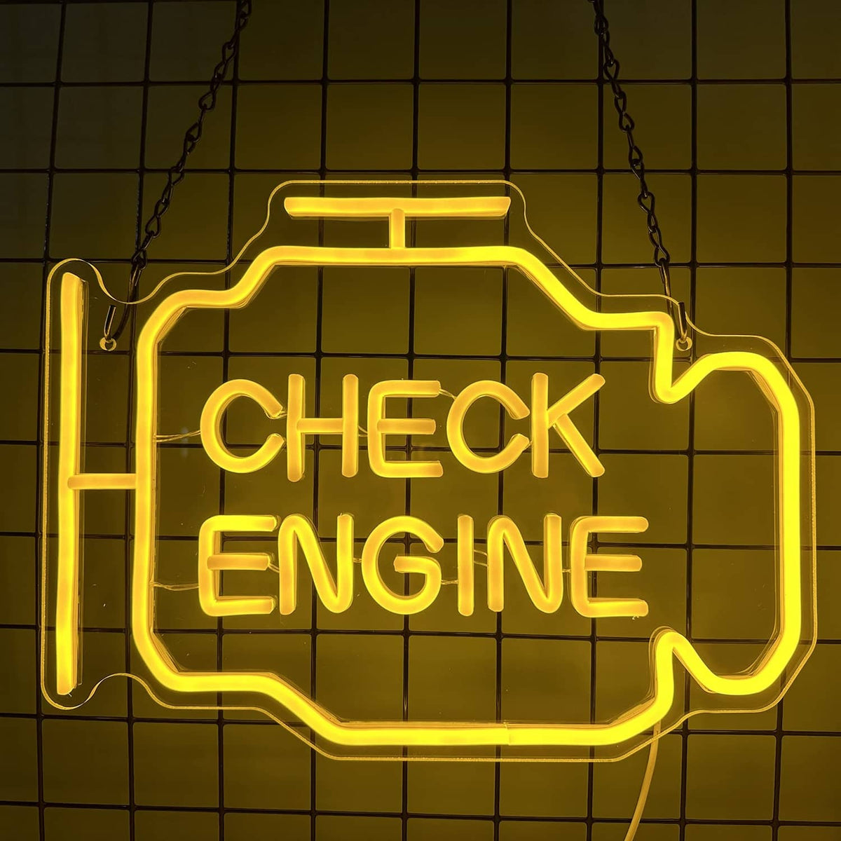 Yellow 'CHECK ENGINE' neon sign in engine-outline frame, hanging by chains.