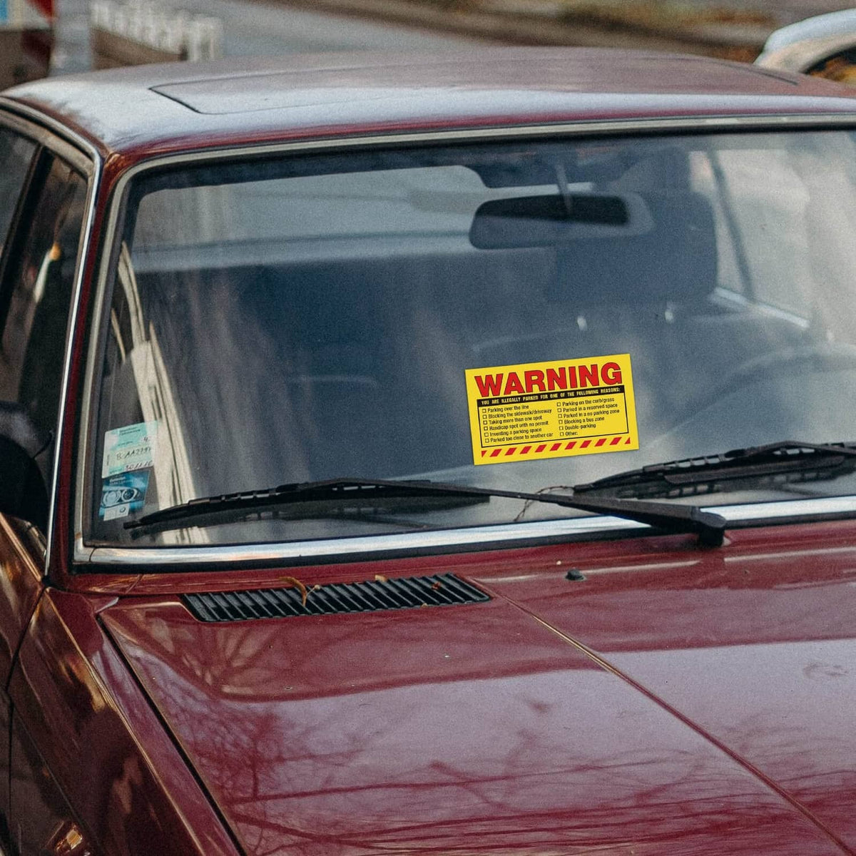 Yellow warning parking violation sticker on car dashboard