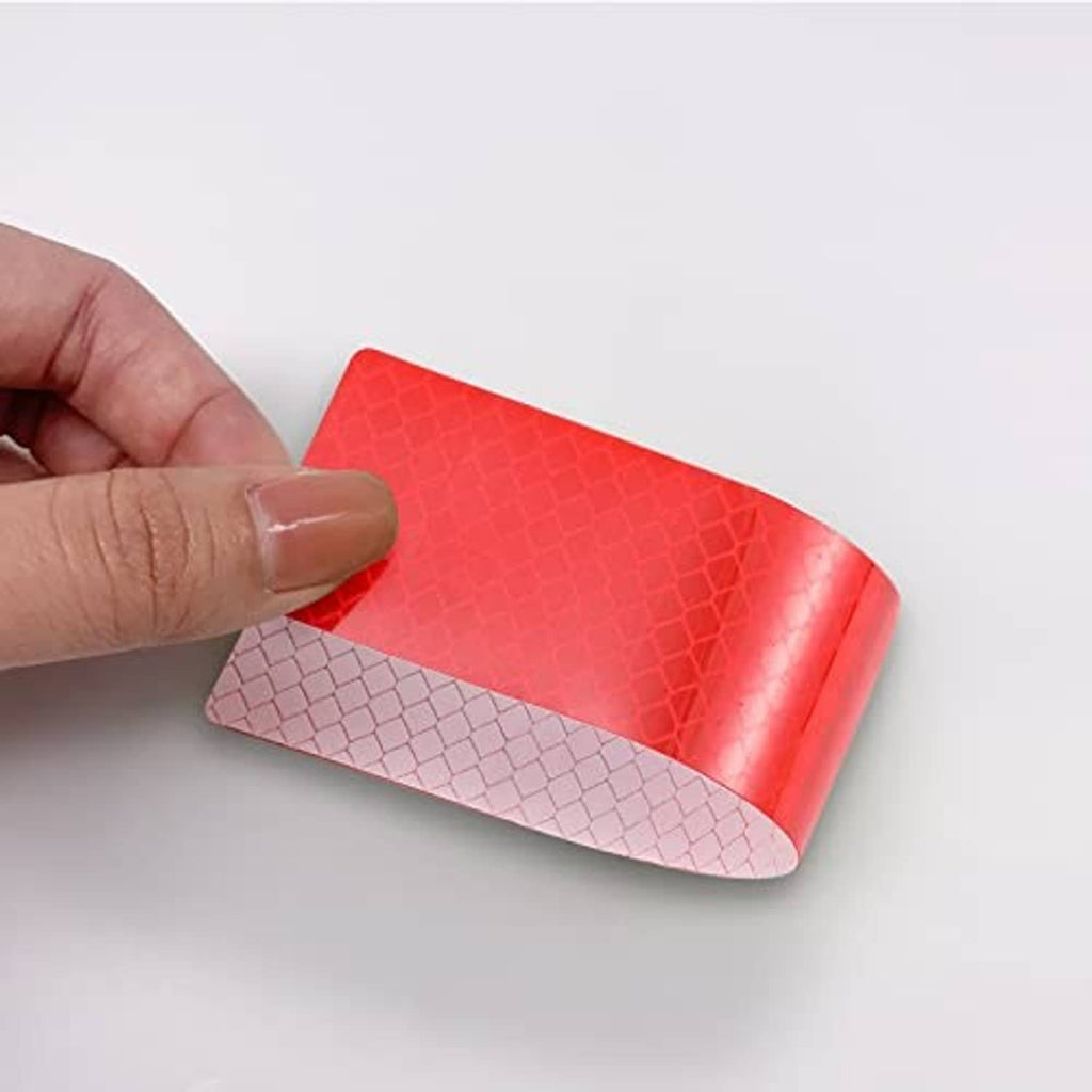 Close-up of red reflective anti-scratch sticker sheet with textured hex pattern