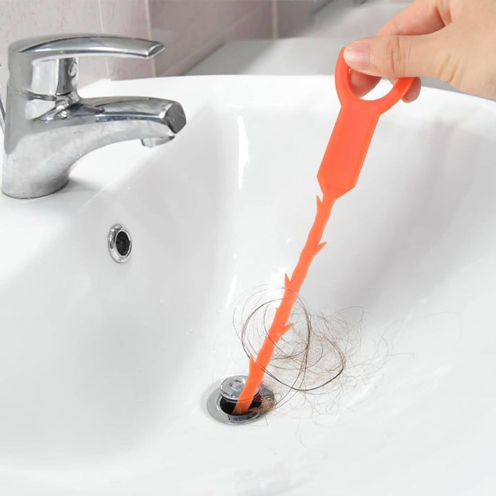 Mini sink plunger removing hair clog; yellow cup and short black ridged handle