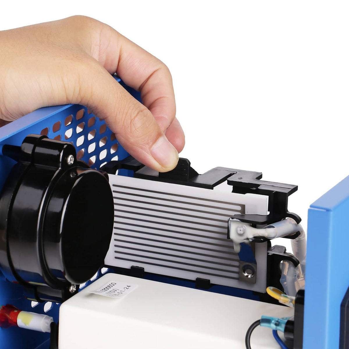 Ceramic ozone plate being installed into an ozone generator by hand