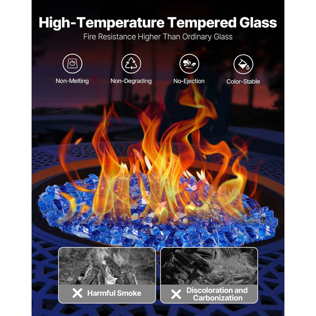 Cobalt blue tempered glass rocks spread in a round fire pit with flames