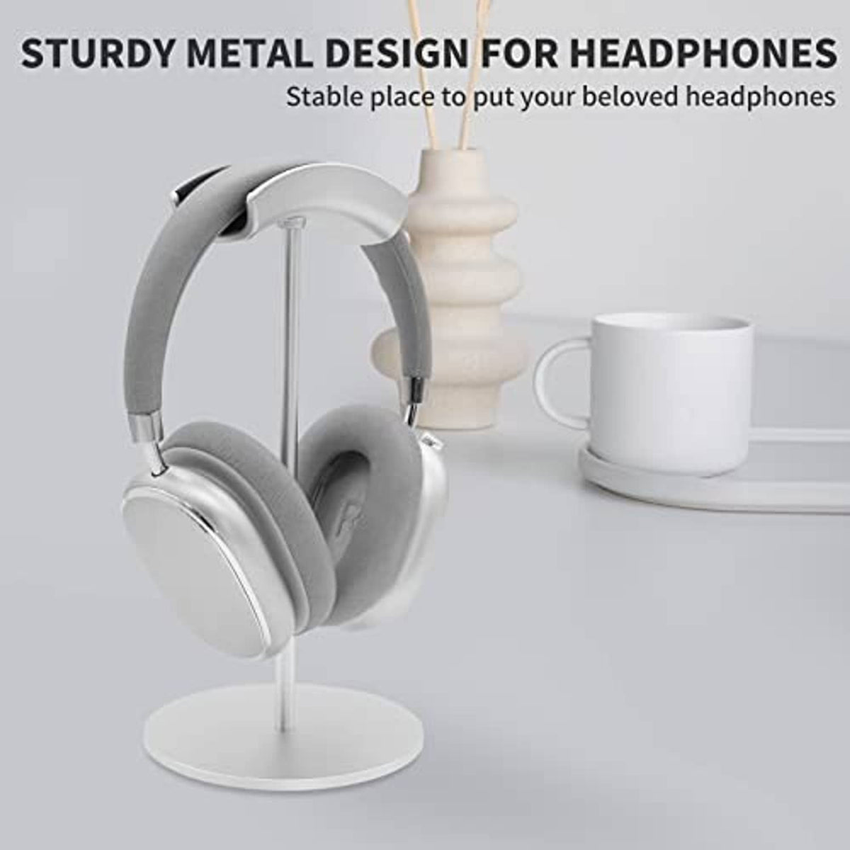 Silver metal headphone stand with gray over-ear headphones and padded top cradle
